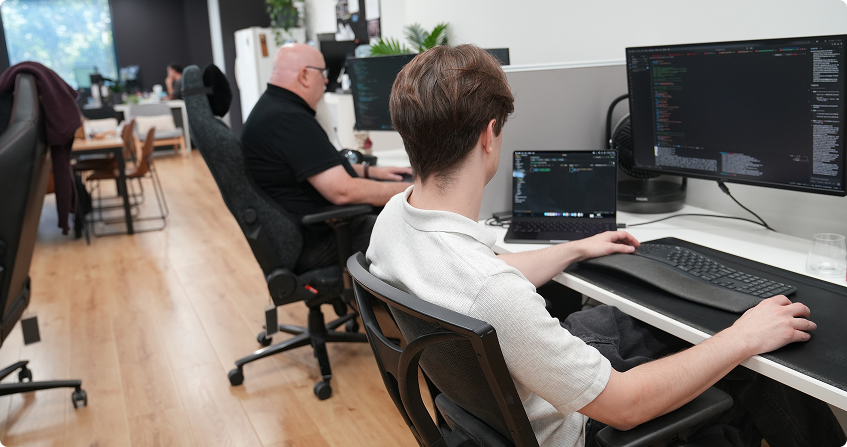 paladine systems developers building a custom booking platform at dual monitor workstations in the norwest office.
