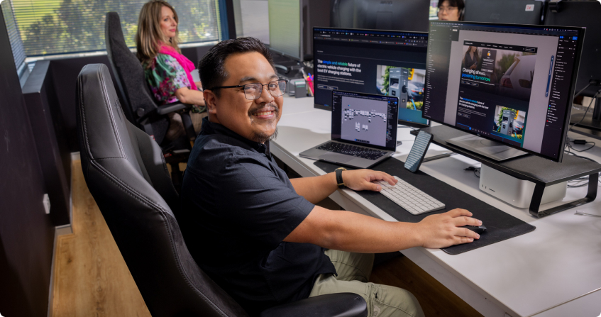office photoshoot showing two team members working on building a custom landing page.